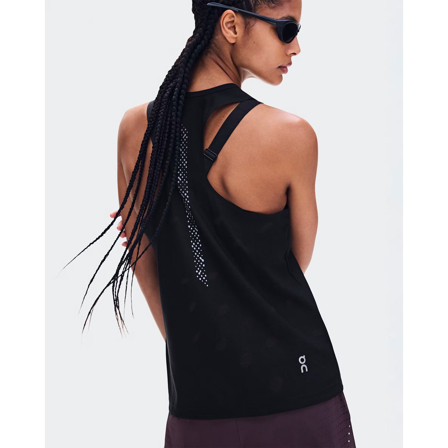 Women's On Zero Tank Breathe Black back view on female runner showing athletic racerback jacquard ventilation with reflective detailing and On DryTec moisture-wicking construction