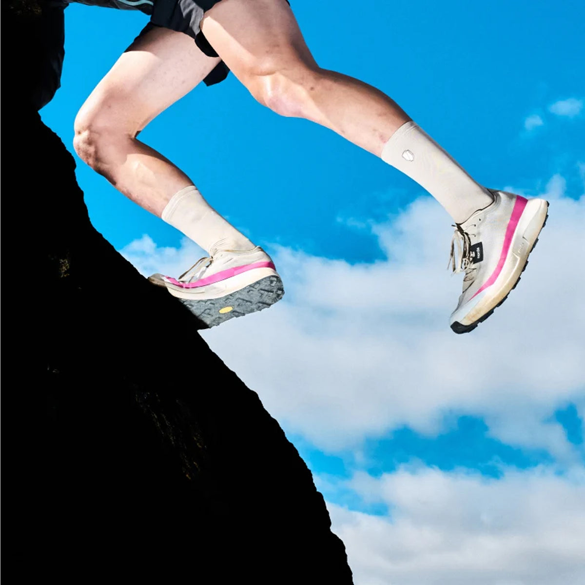 Women's norda 005 Trail Running Shoes Comet side view on female trail runner showing lightest trail super shoe with Arnitel TPEE midsole and Vibram Megagrip Elite for maximum energy return and stability during technical trail racing
